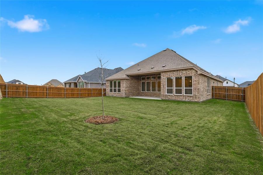 Back of property with a patio area, brick siding, and a fenced backyard