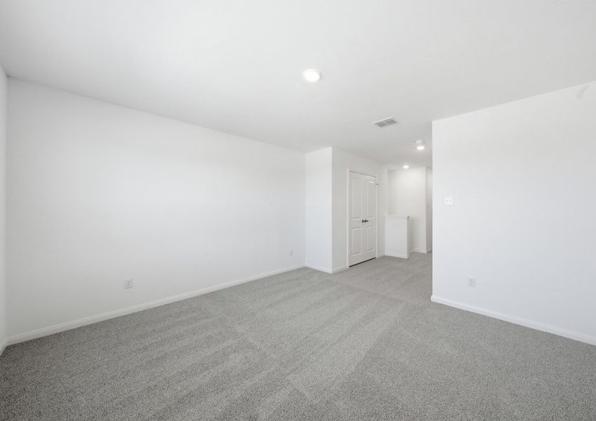Second-floor game room featuring wood-look vinyl flooring and neutral wall color. Second-floor game room featuring wood-look vinyl flooring and neutral wall color.