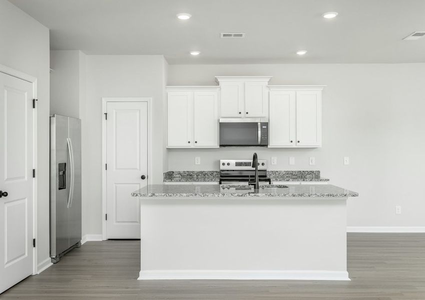 The kitchen has designer wood cabinetry