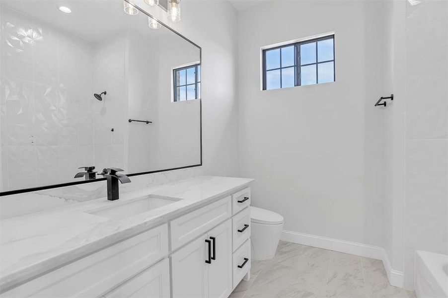 Full bathroom with vanity, tub / shower combination, tile patterned flooring, and toilet