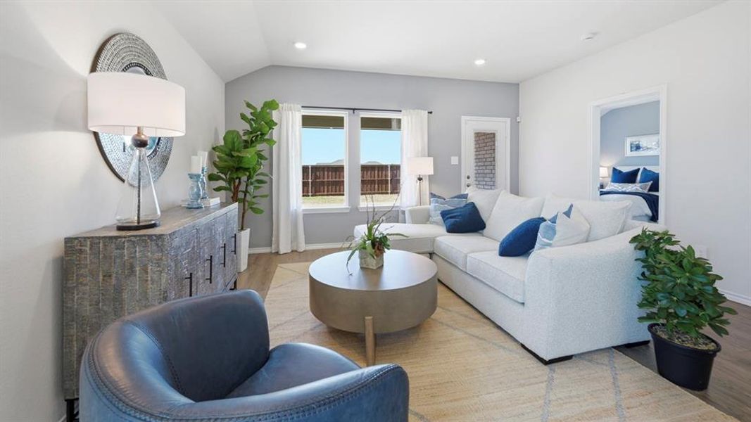 The living area features recessed lighting, large windows, and durable flooring, creating an inviting atmosphere