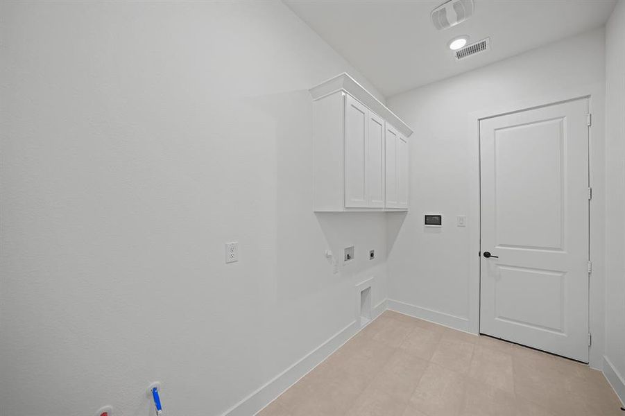 Laundry area with electric dryer hookup, cabinet space, gas dryer hookup, hookup for a washing machine, and recessed lighting
