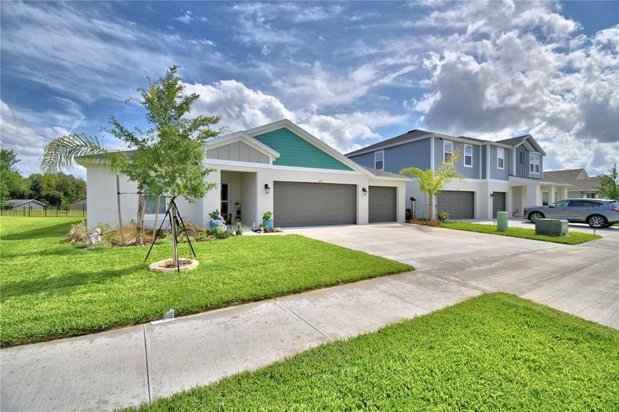 Front exterior of a new home in Harmony at Lake Eloise, Winter Haven, FL, highlighting curb appeal (Image 24).