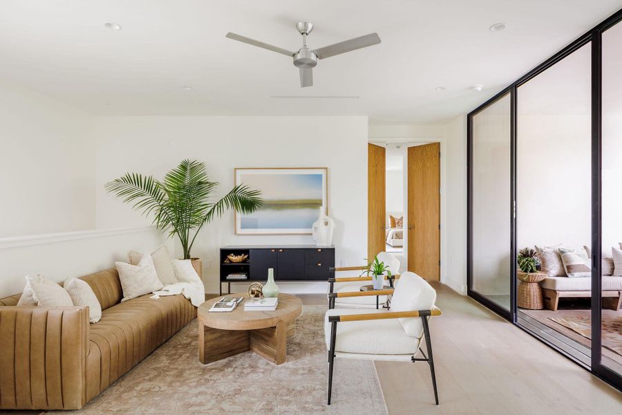 Living room featuring light wood-style flooring, a ceiling fan, and recessed lighting Living room featuring light wood-style flooring, a ceiling fan, and recessed lighting