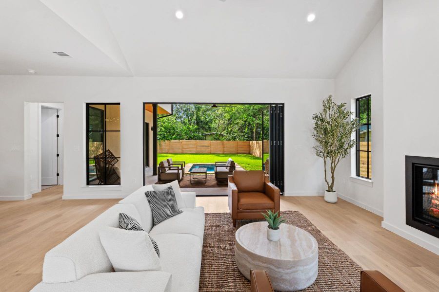 A spacious living area seamlessly transitions to a tranquil outdoor retreat with a pool. A spacious living area seamlessly transitions to a tranquil outdoor retreat with a pool.