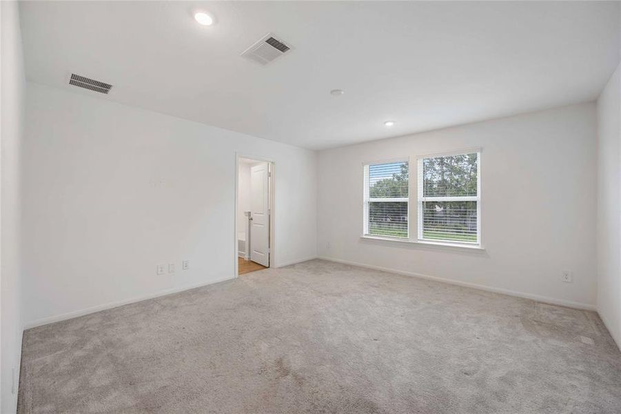 Primary Bedroom Overlooking Backyard!