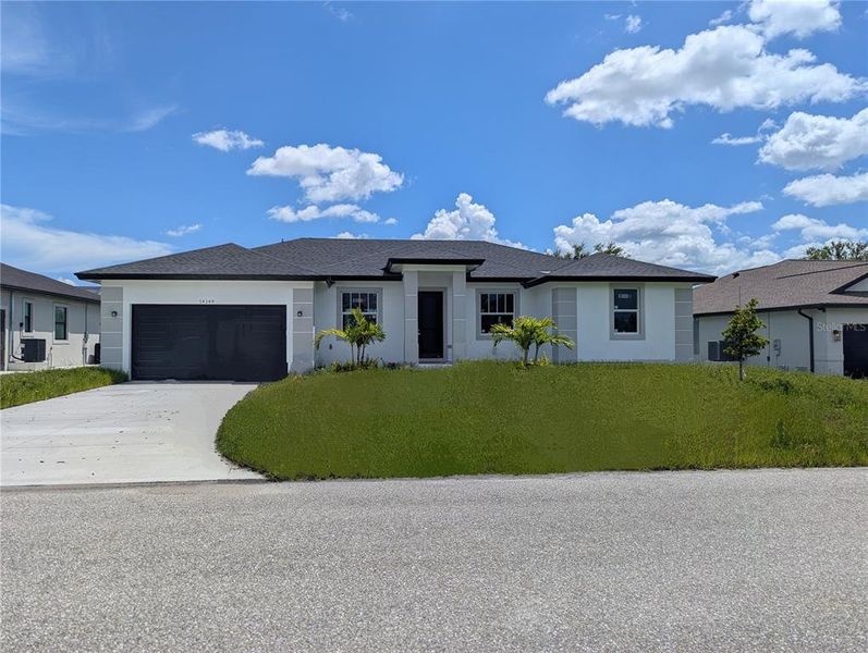 Front exterior of a new home in , Port Charlotte, FL, highlighting curb appeal (Image 1).