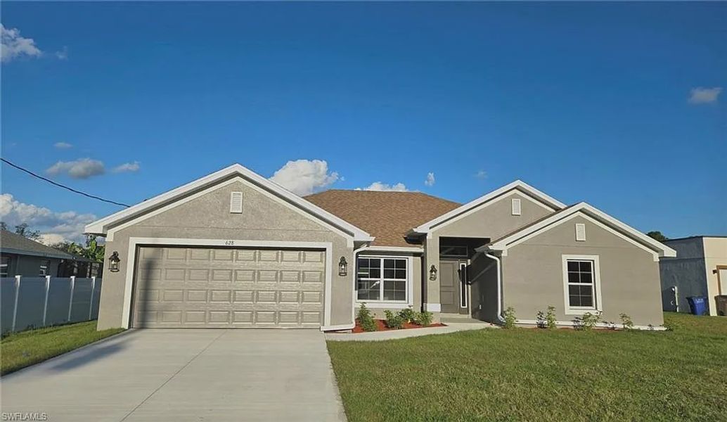 Front exterior of a new home in Greenbriar, Lehigh Acres, FL, highlighting curb appeal (Image 1).