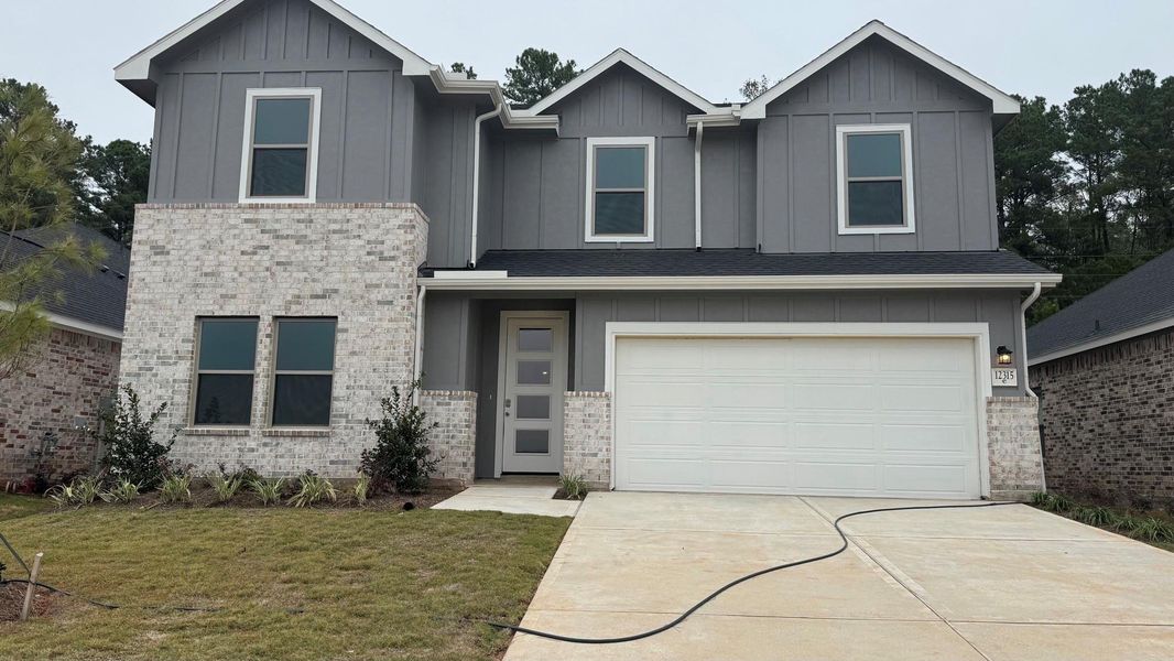 Front exterior of a new home in Westridge Cove, Conroe, TX, highlighting curb appeal (Image 2).