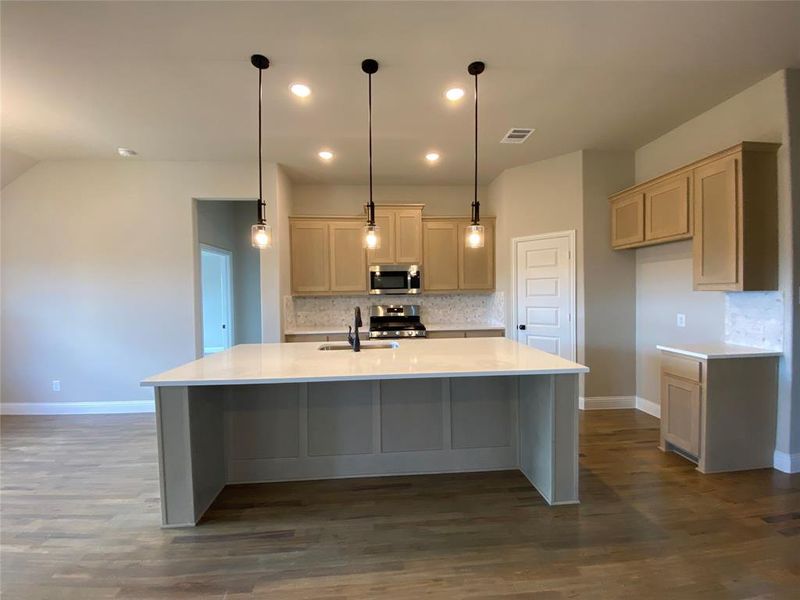 Island has cabinet color visible from all sides like a custom furniture piece Island has cabinet color visible from all sides like a custom furniture piece