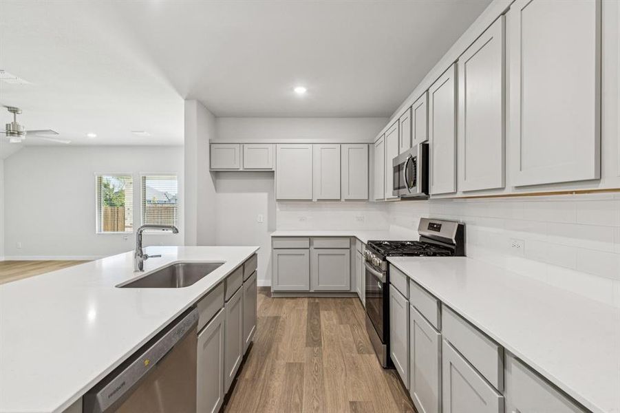 Kitchen in the Oscar home plan by Trophy Signature Homes – REPRESENTATIVE PHOTO