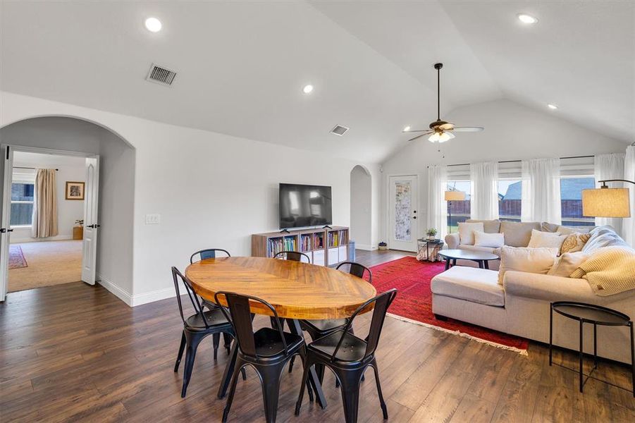 Dining space featuring ceiling fan, dark hardwood / wood-style floors, and lofted ceiling