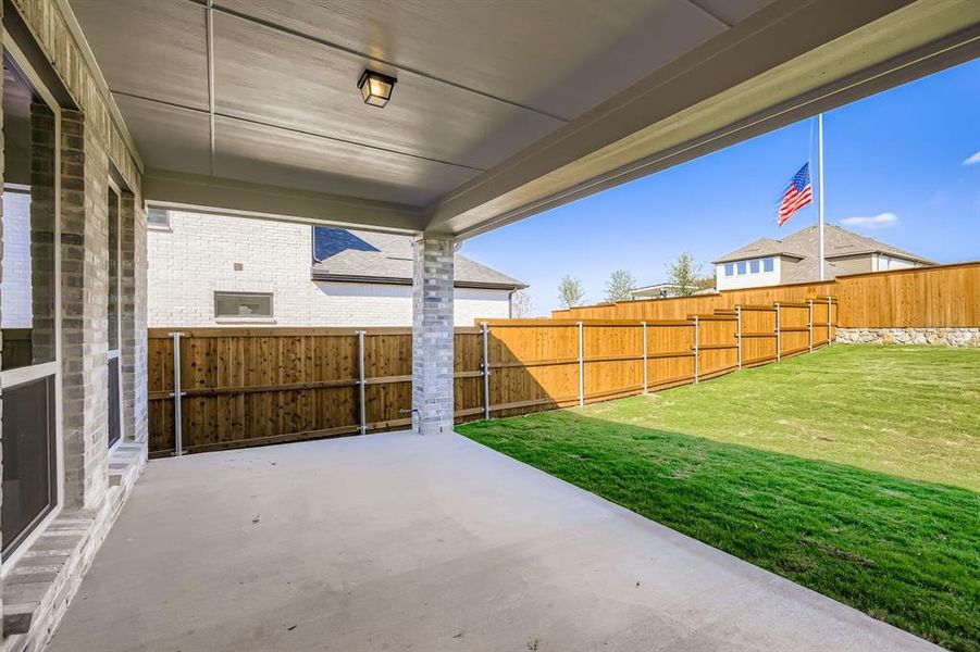 Fenced backyard featuring a patio area Fenced backyard featuring a patio area