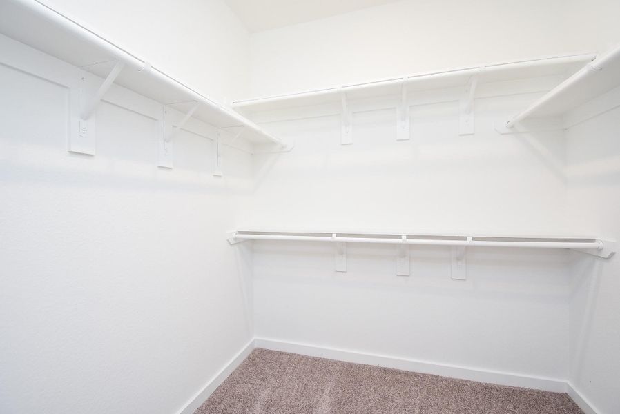 Wow! This primary carpeted walk-in closet is the answer to your storing and organizing dreams, all in one amazing place!
