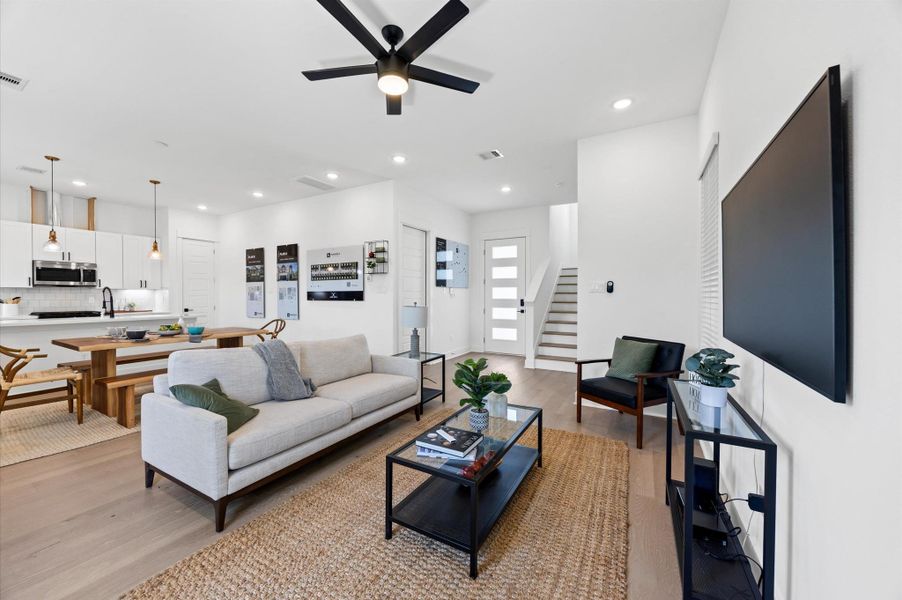 The open layout connects effortlessly to the kitchen, where a stylish island doubles as a dining space. High ceilings and strategically placed lighting enhance the airy feel, making the space ideal for both relaxation and entertaining. The open layout connects effortlessly to the kitchen, where a stylish island doubles as a dining space. High ceilings and strategically placed lighting enhance the airy feel, making the space ideal for both relaxation and entertaining.