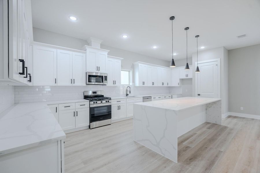 Modern kitchen features high-end finishes and an oversized islandModern kitchen features high-end finishes and an oversized island