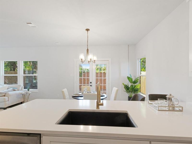 Kitchen featuring pendant lighting, sink, and french doors