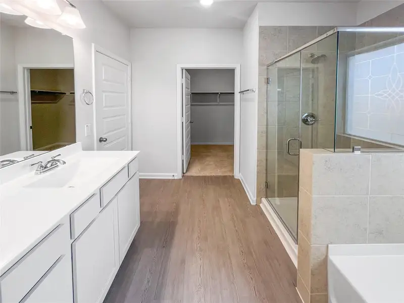The Waring III- Primary Bathroom with Dual Vanities, Separate Garden tub and Walk-in Shower. Sample image for illustration; upgrades, options, and colors may vary. The Waring III- Primary Bathroom with Dual Vanities, Separate Garden tub and Walk-in Shower. Sample image for illustration; upgrades, options, and colors may vary.