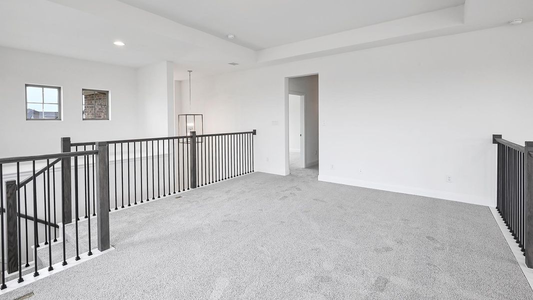 Empty room featuring carpet floors, recessed lighting, baseboards, a raised ceiling, and a smoke detector
