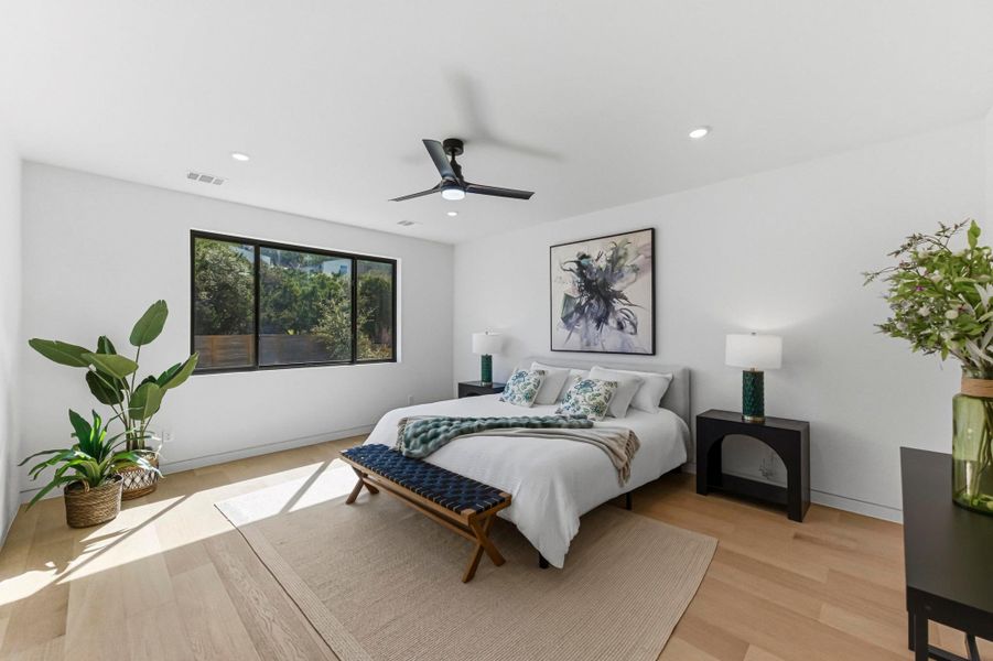 Bedroom featuring light wood finished floors, ceiling fan, and recessed lighting