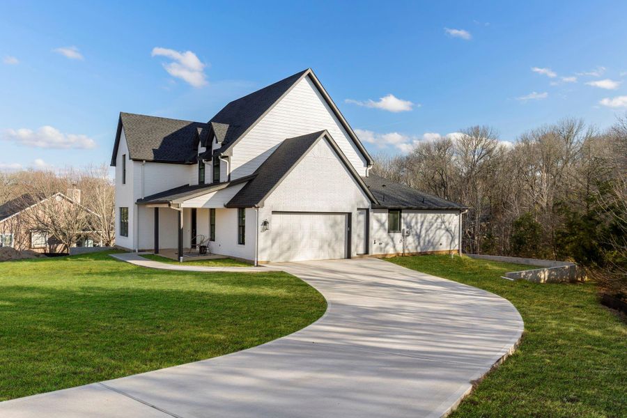 Front exterior of a new home in , Brenham, TX, highlighting curb appeal (Image 26).
