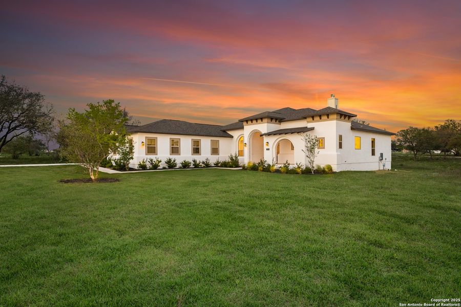 Front exterior of a new home in Legend Park, Castroville, TX, highlighting curb appeal (Image 20). Front exterior of a new home in Legend Park, Castroville, TX, highlighting curb appeal (Image 20).