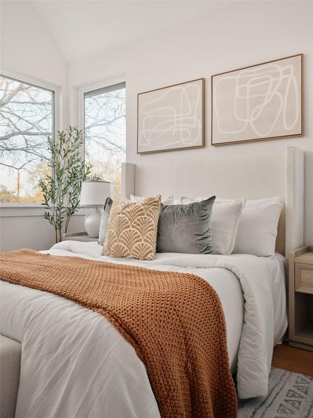 Bedroom featuring vaulted ceiling and wood finished floors