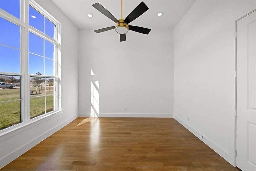 Empty room featuring dark wood-style floors, recessed lighting, and a ceiling fan Empty room featuring dark wood-style floors, recessed lighting, and a ceiling fan