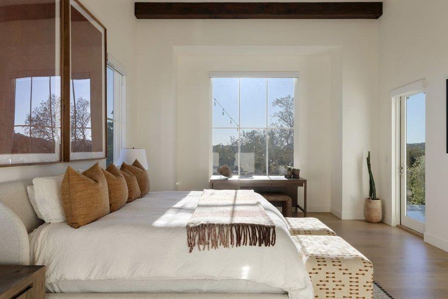 Bedroom featuring access to outside and dark wood-style flooring
