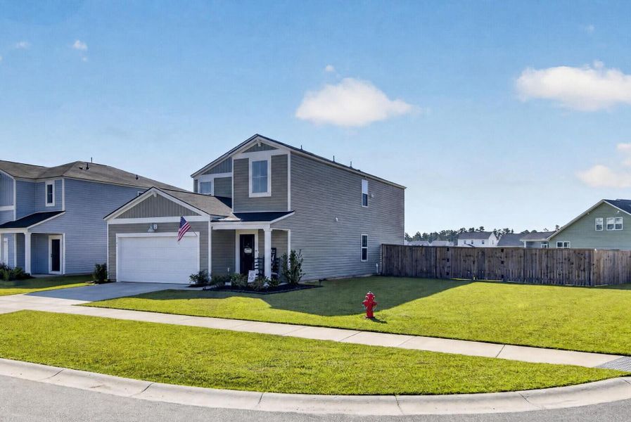 Front exterior of a new home in Lindera Preserve at Cane Bay Plantation, Summerville, SC, highlighting curb appeal (Image 20).