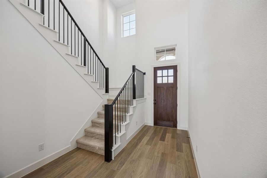 With a stunning open railing stair case, this gorgeous entry area is the perfect place to welcome family and friends!