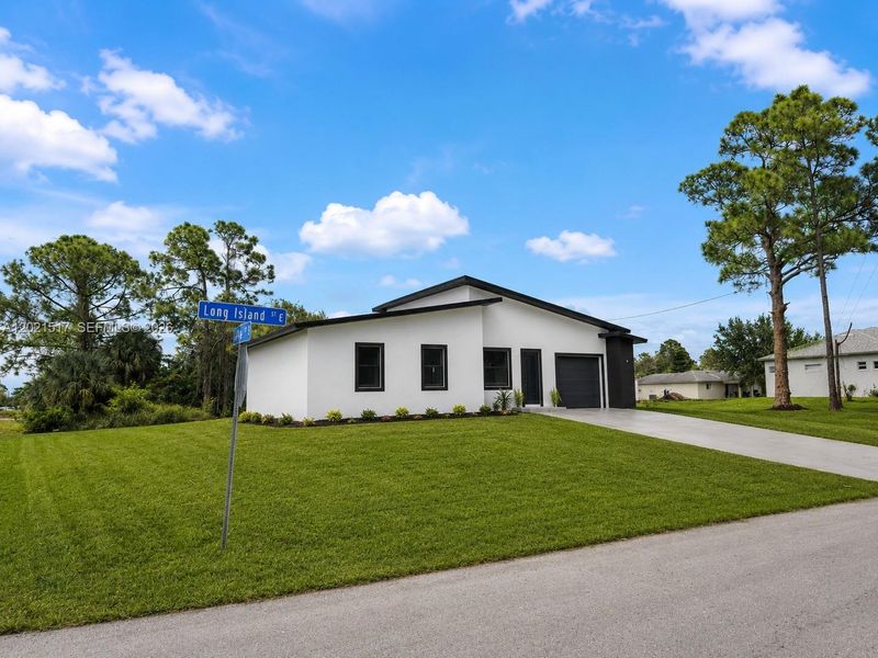 Front exterior of a new home in , Lehigh Acres, FL, highlighting curb appeal (Image 2). Front exterior of a new home in , Lehigh Acres, FL, highlighting curb appeal (Image 2).