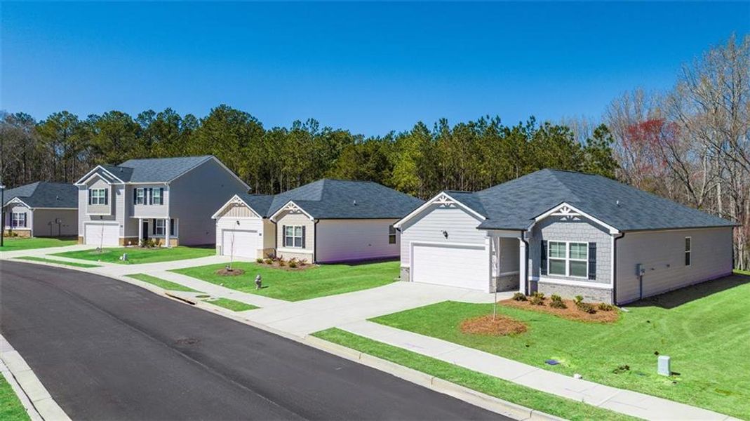 Front exterior of a new home in Champion's Run, Lithonia, GA, highlighting curb appeal (Image 16). Front exterior of a new home in Champion's Run, Lithonia, GA, highlighting curb appeal (Image 16).