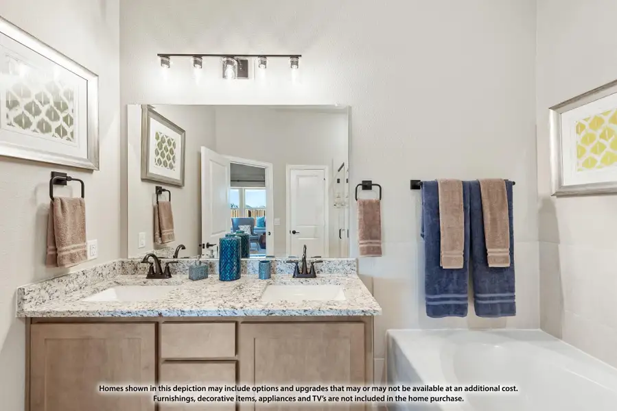 Bathroom with double sink vanity, granite countertop, large mirror, and soaking tub beside tiled wall. Bathroom with double sink vanity, granite countertop, large mirror, and soaking tub beside tiled wall.