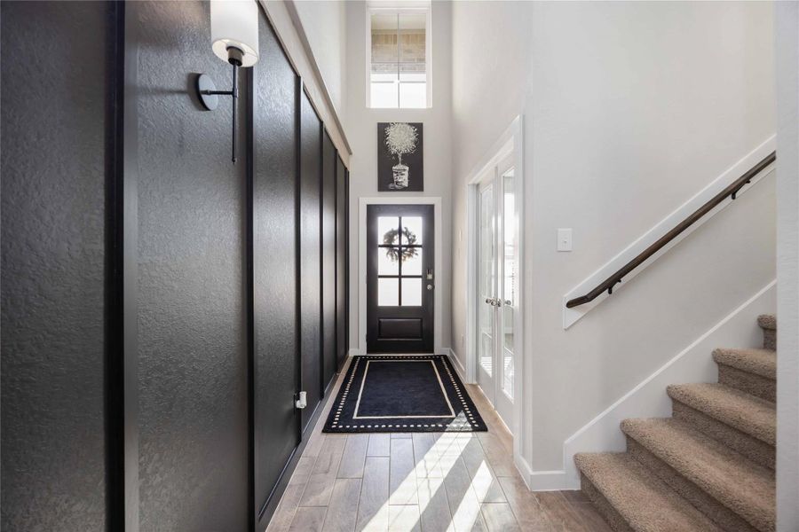 Foyer with high ceilings and view into main living area. Foyer with high ceilings and view into main living area.