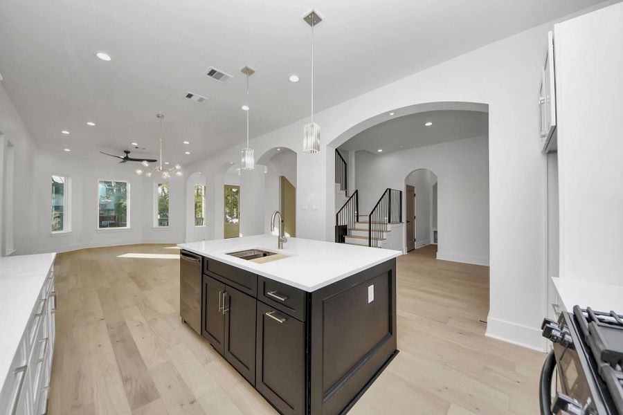 The bold island adds a spark to the kitchen, while the sleek faucet and functional sink come with thoughtful extras, including a cutting board and metal drainer for added convenience. The bold island adds a spark to the kitchen, while the sleek faucet and functional sink come with thoughtful extras, including a cutting board and metal drainer for added convenience.