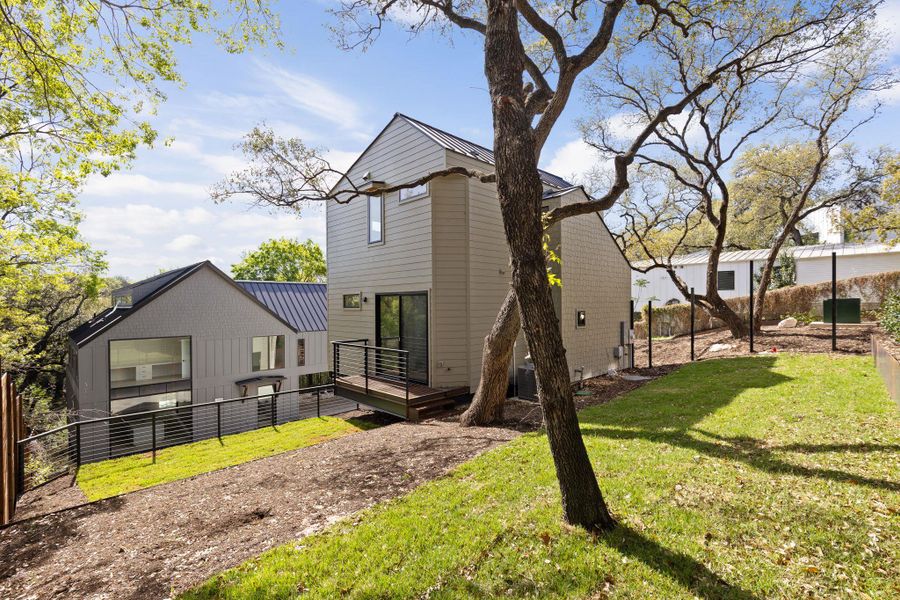 Rear view of property featuring a deck and a metal roof