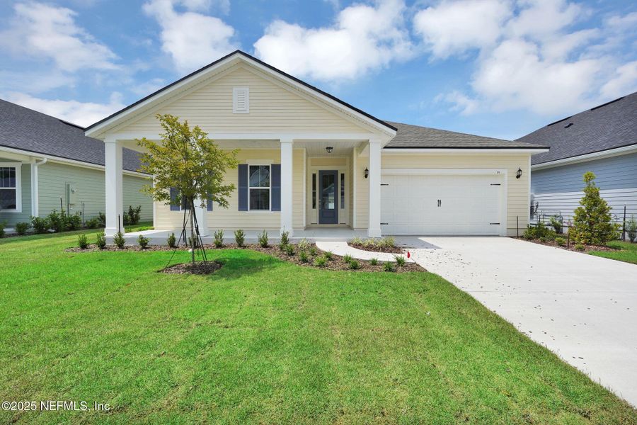 Front exterior of a new home in Forest Park at Wildlight, Yulee, FL, highlighting curb appeal (Image 19). Front exterior of a new home in Forest Park at Wildlight, Yulee, FL, highlighting curb appeal (Image 19).