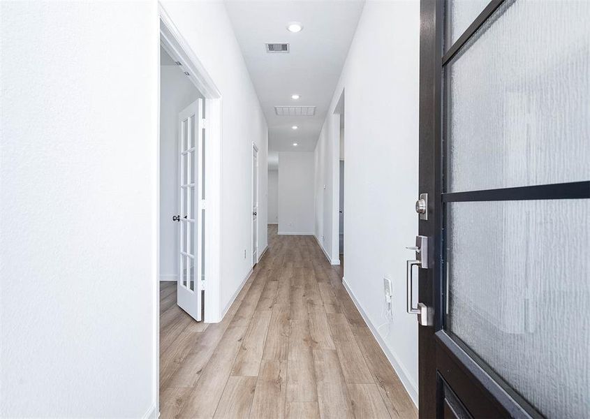 Bright and airy! The wide entryway with wood-look flooring and sleek finishes leads you to the heart of the home.