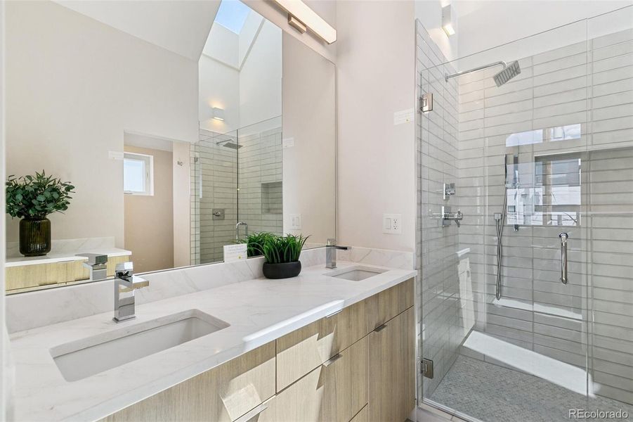 Incredible Primary Bath with Skylight! Dual sinks and shower heads with shower wand!