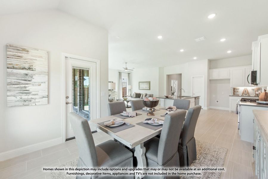 Open-concept dining area with six-seat table, light wood floors, and kitchen visible in background Open-concept dining area with six-seat table, light wood floors, and kitchen visible in background