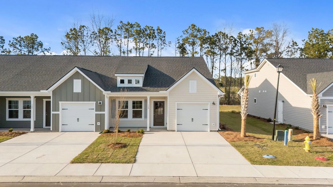 Front exterior of a new home in Blue Heron Retreat, Little River, SC, highlighting curb appeal (Image 2). Front exterior of a new home in Blue Heron Retreat, Little River, SC, highlighting curb appeal (Image 2).