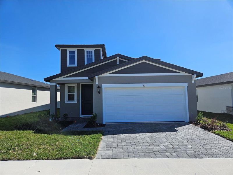 Front exterior of a new home in The Reserve at Hammock Oaks - Classic Series, Lady Lake, FL, highlighting curb appeal (Image 1).
