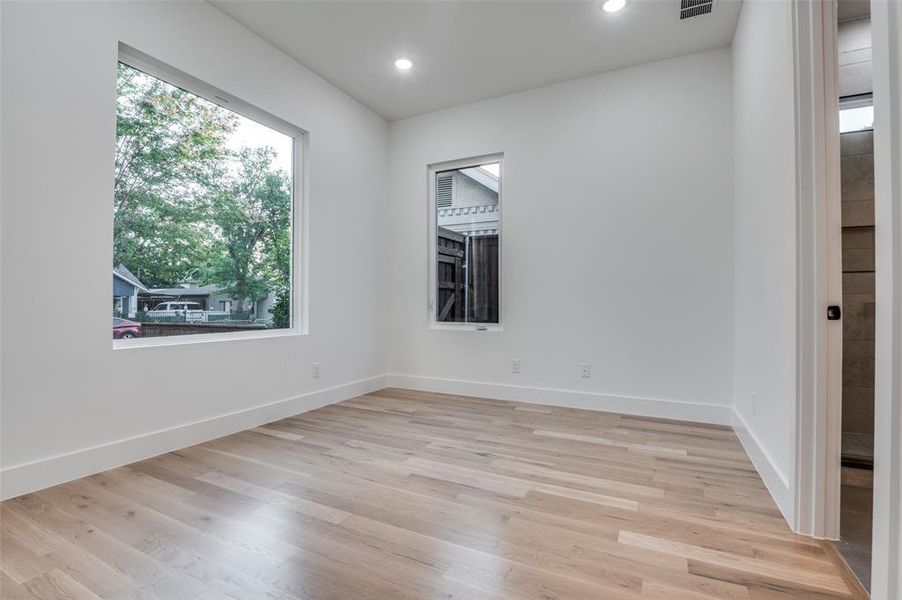 Empty room featuring light wood finished floors and recessed lighting Empty room featuring light wood finished floors and recessed lighting