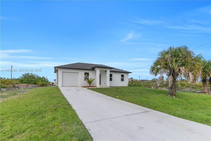 Front exterior of a new home in , Lehigh Acres, FL, highlighting curb appeal (Image 23).