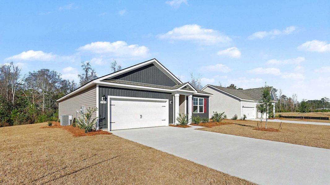 Front exterior of a new home in Pinewood Estates, Conway, SC, highlighting curb appeal (Image 2). Front exterior of a new home in Pinewood Estates, Conway, SC, highlighting curb appeal (Image 2).