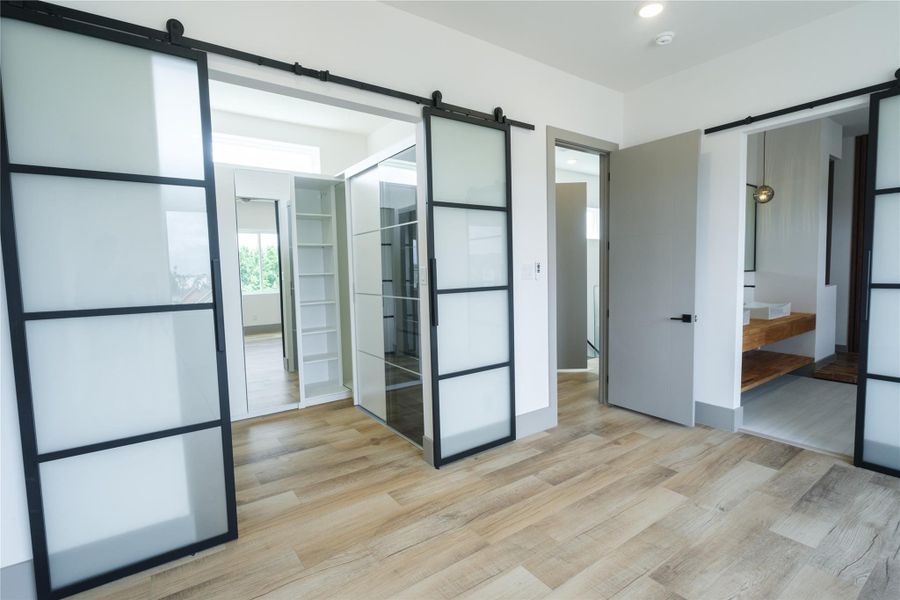 Representative Primary Closet (Design selections and colors may vary): The thoughtfully designed walk-in closet features a clean white finish with plenty of drawers, shelving and hanging space to keep items organized, uncluttered and looking neat. Bonus with clerestory windows to provide soft natural light while maintaining privacy.