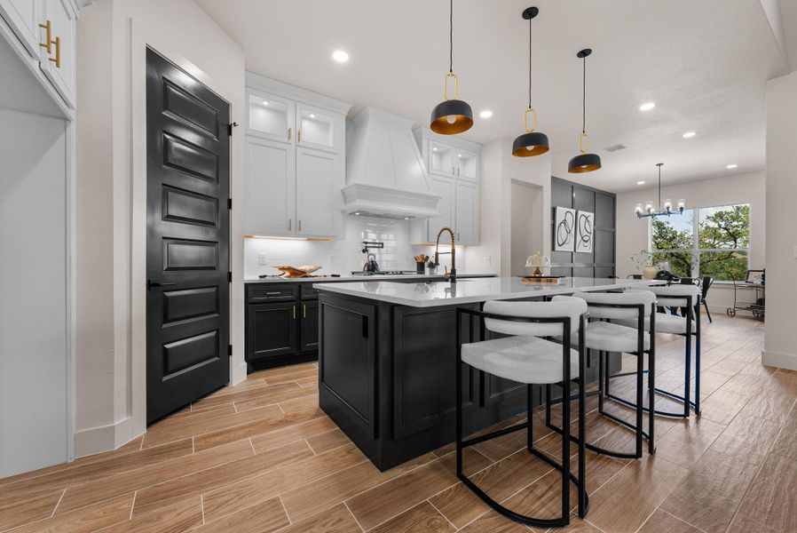 A well-appointed kitchen features a large island with seating, ideal for gathering.