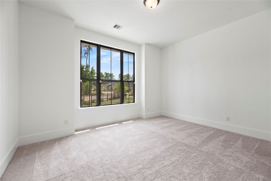 Secondary bedroom which features an ensuite bath in this split plan layout.