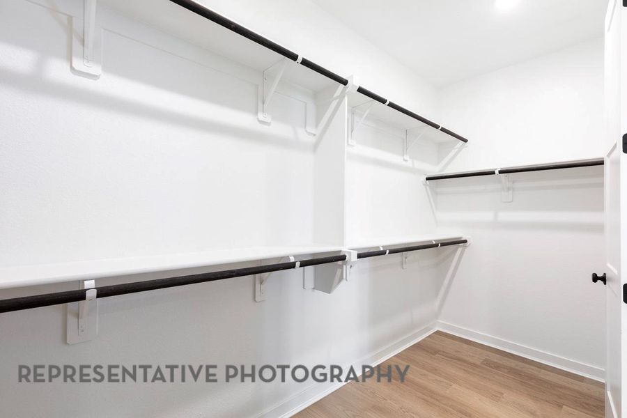 Spacious closet with light wood finished floors Spacious closet with light wood finished floors